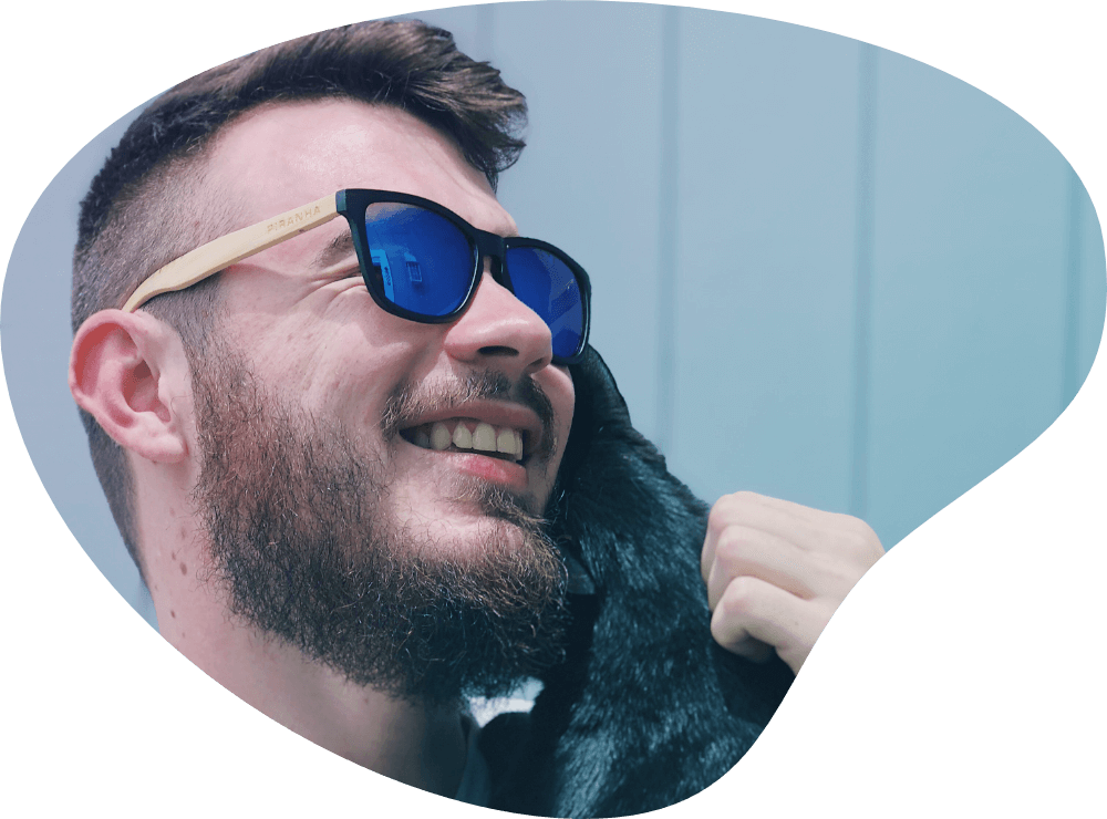 John Bussell holding a cat, smiling.